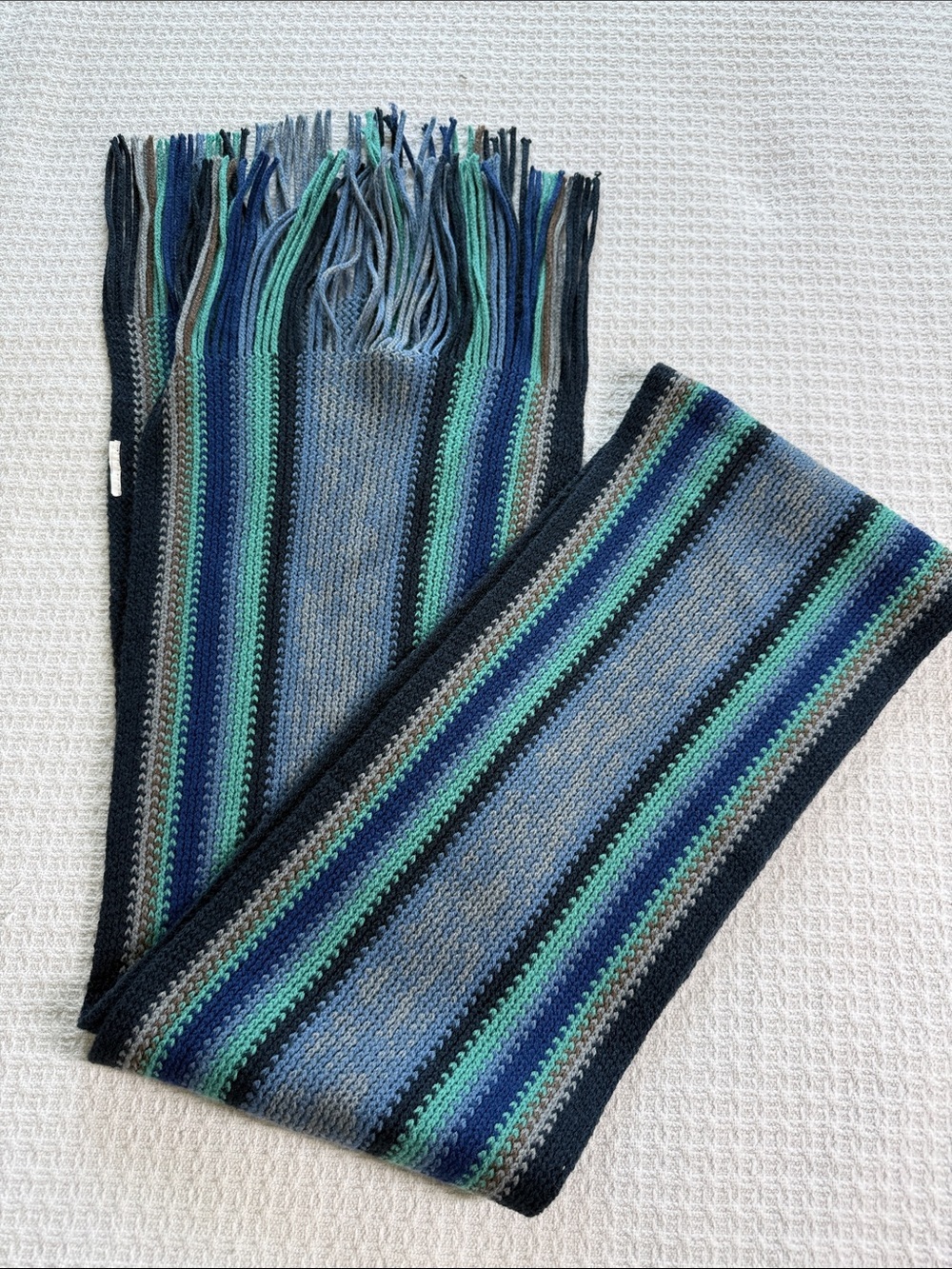 Blue and green striped knit scarf with fringe